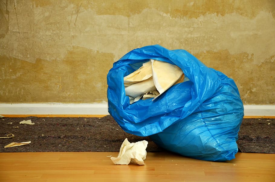 white crumpled paper in blue plastic bag inside brown room HD wallpaper