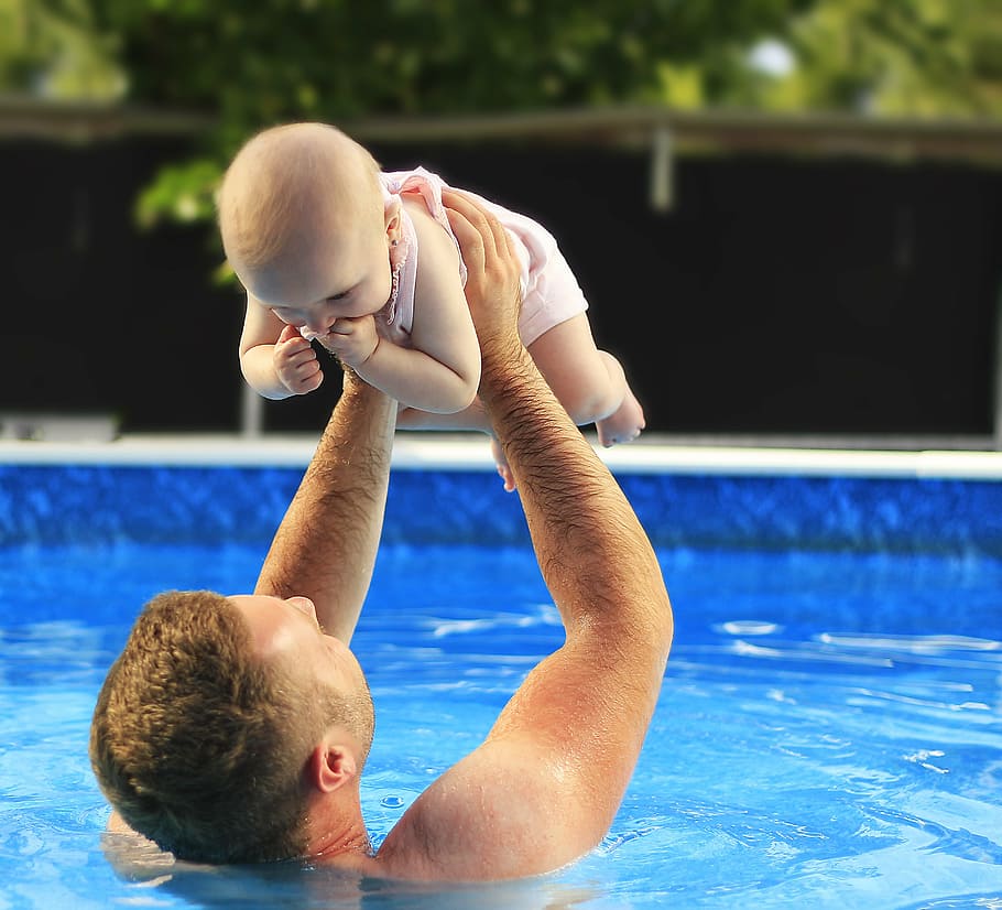father lifting baby on pool during faytime, meringue, family