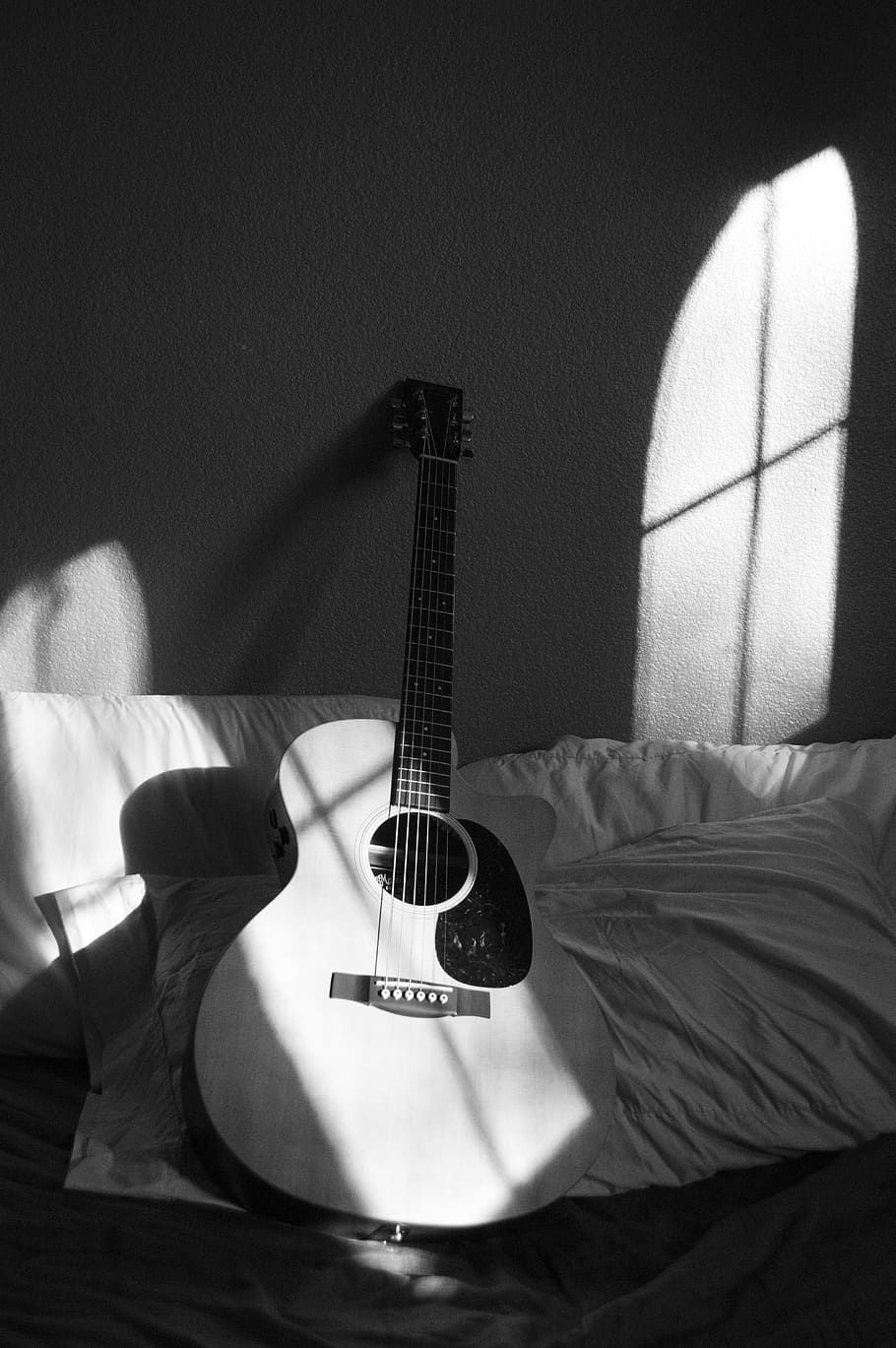 White Acoustic Guitar on Grey and White Textile, black-and-white