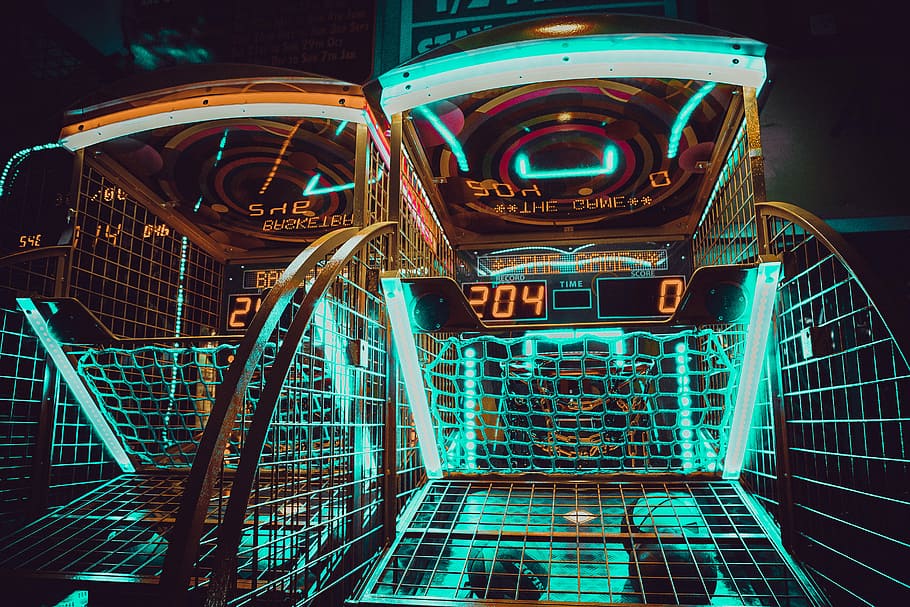 turned on green and brown LED lights, low exposure photo of two basketball arcade machines HD wallpaper
