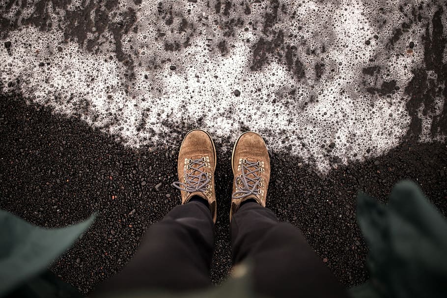 person wearing brown shoes and black pants standing on black asphalt road HD wallpaper