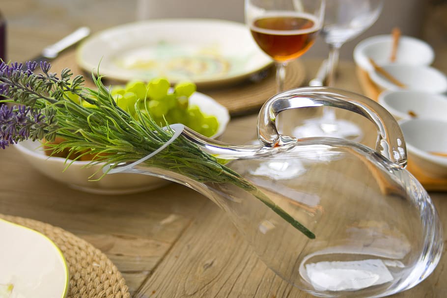 lavender flowers in clear glass pitcher on brown wooden table with dinnerware HD wallpaper