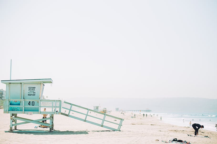 man standing in front of green wooden life guard station in seashore during day time, lifeguard station during daytime HD wallpaper