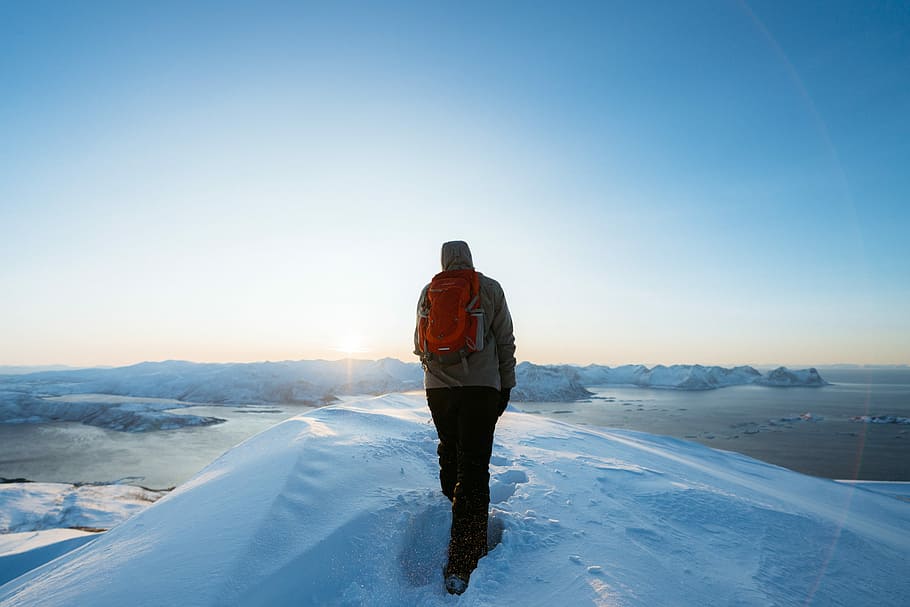 man walking on snow during daytime, man standing on white snow taken at daytime HD wallpaper
