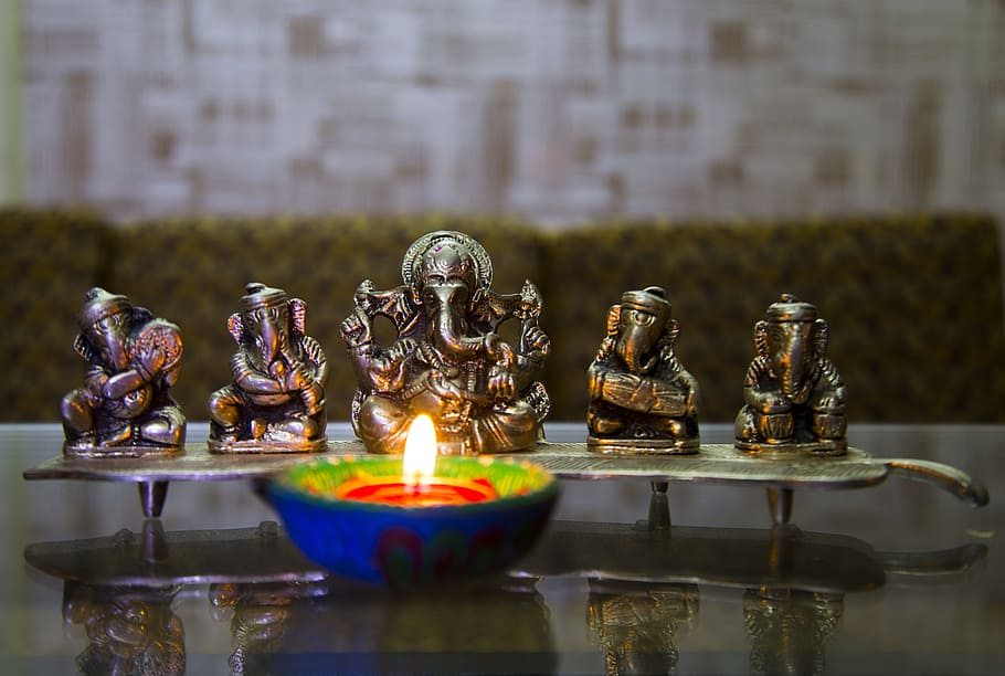 selective focus photography of Ganesha figurine, puja, deepavali