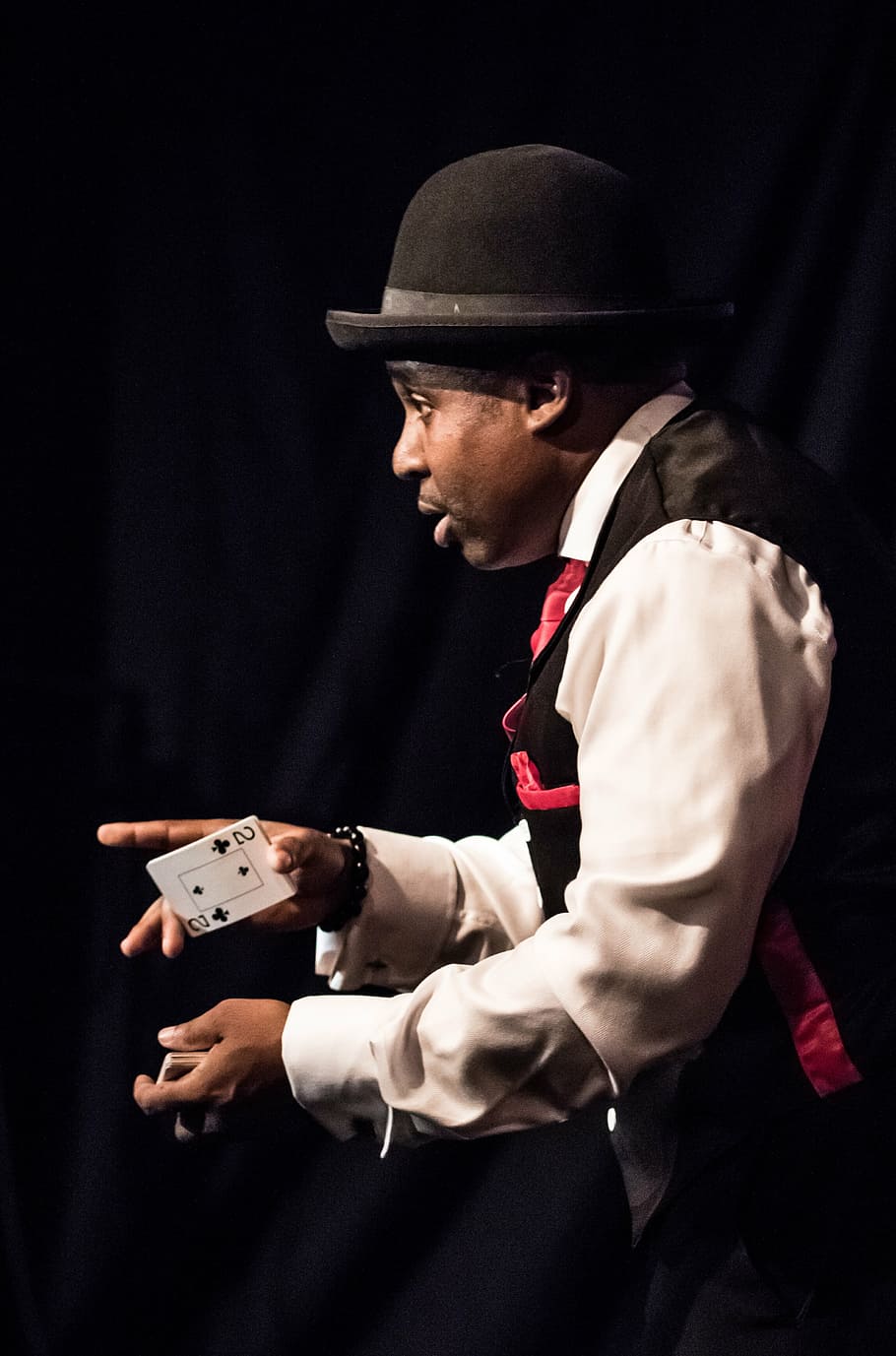A card magician demonstrating a card trick.