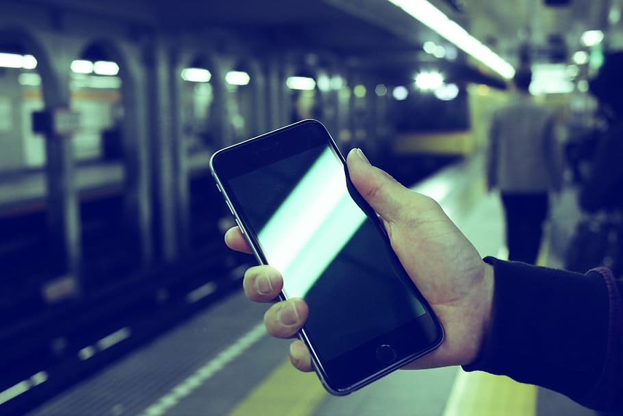 selective focus photo of person holding turned-off space gray iPhone 6 HD wallpaper