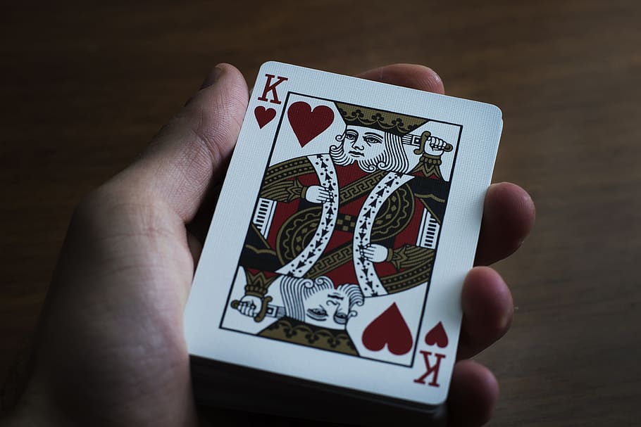 person holding king of heart playing card, hand, playing cards