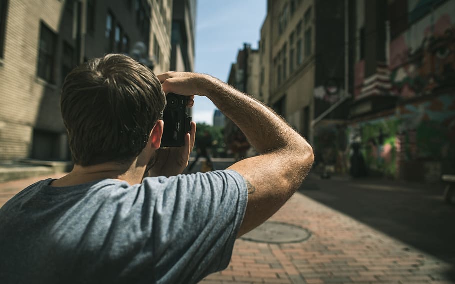 man in gray t-shirt standing on pavement near buildings, guy HD wallpaper