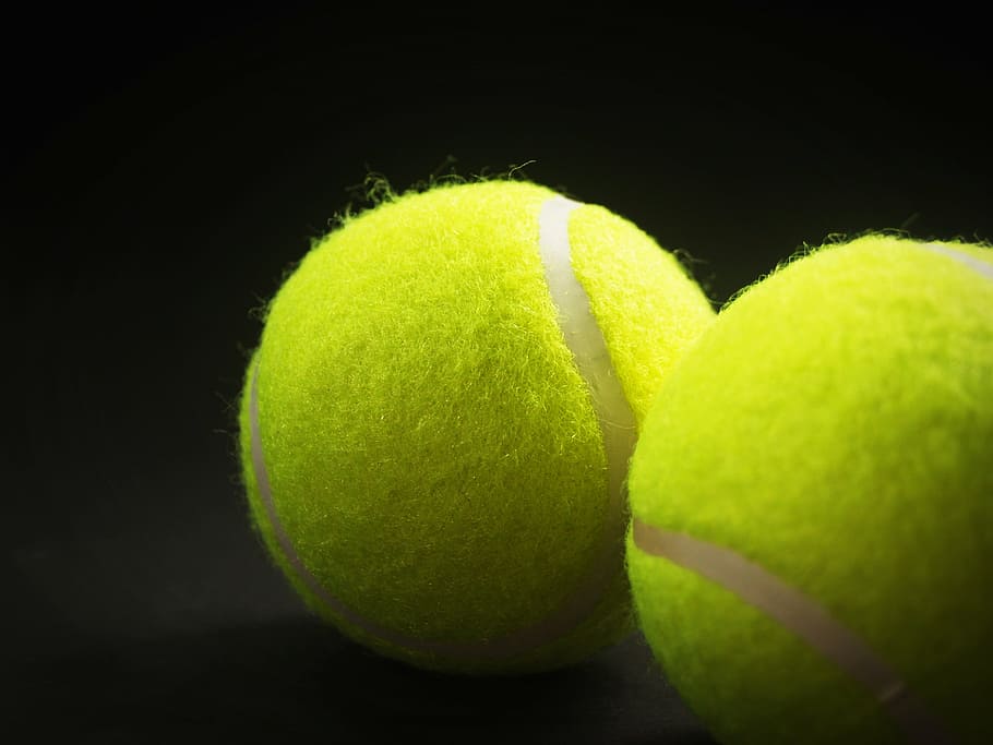 two tennis balls, racket, white, yellow, background, closeup