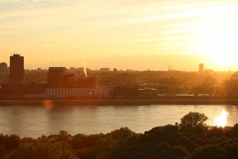 sunset near calm body of water, cityscape, sky, river, buildings HD wallpaper