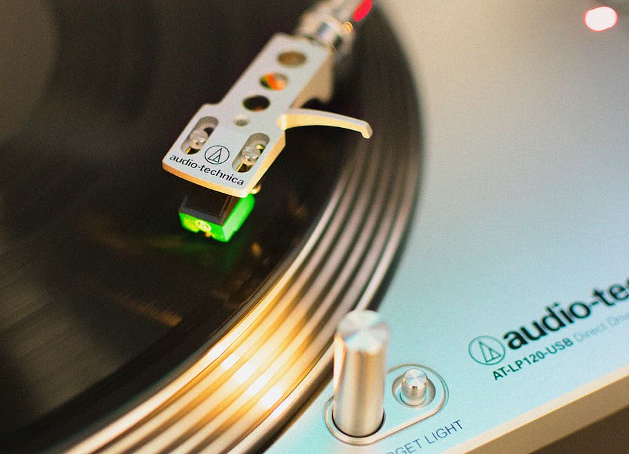 close up photo of DJ mixer, gray Audio-Technica turntable, vinyl