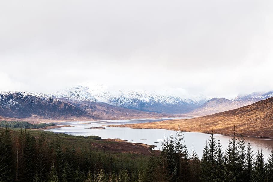 body of water between mountains under cloudy sky, view of trees, lake and mountains HD wallpaper