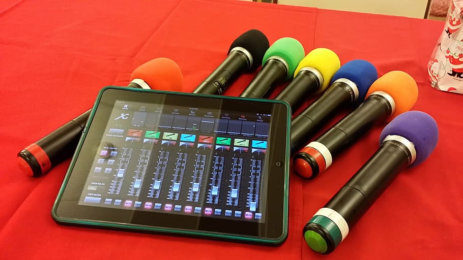 assorted-color microphones and black iPad on red textile, wireless HD wallpaper