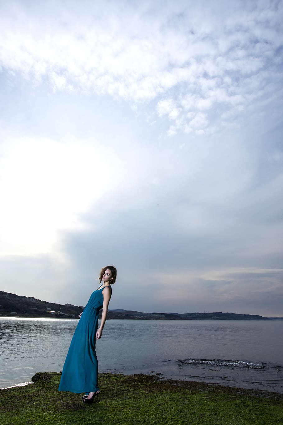 woman standing near body of water wearing blue dress, women's