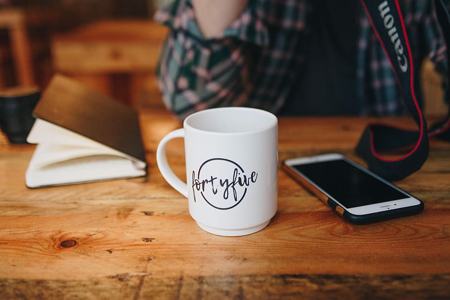 ceramic mug beside a phone on table, white ceramic mug, wireless technology HD wallpaper