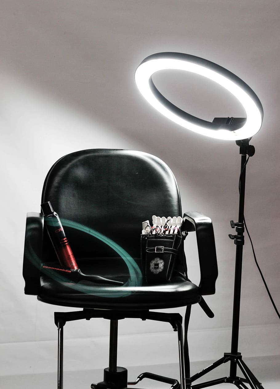 red and black steel tube on black leather padded chair, black armchair beside rim light with stand, HD wallpaper