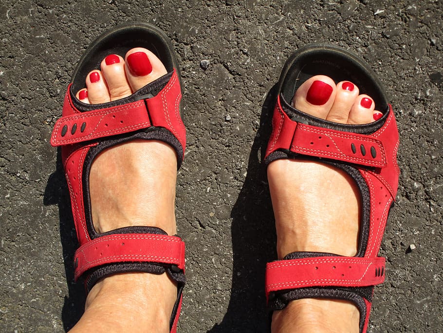 woman wearing pair of red-and-black sandals, feet, beauty, fashion