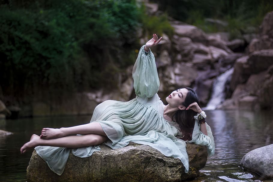 woman lying on large stone between flowing river, woman laying down on rock, HD wallpaper