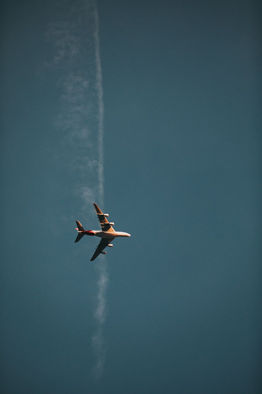 low-angle photo of white air plane, white and red passenger plane flying under blue sky during daytime HD wallpaper