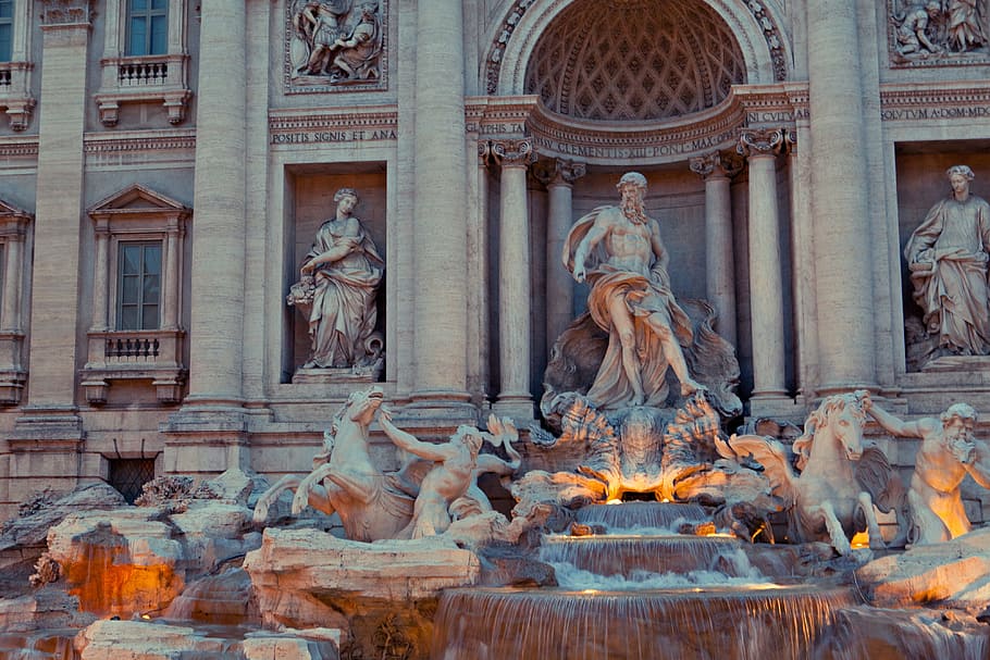 An early evening shot of the architectural details of the world-famous Trevi Fountain statue in Rome, Italy