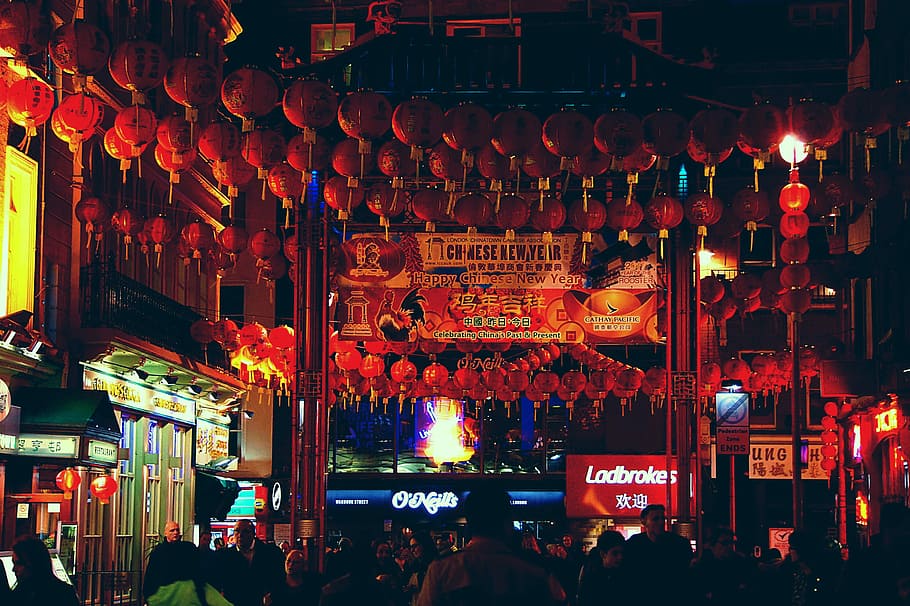 Lost in China Town, people walking on street with lots of red chinese lanterns hang at nighttime