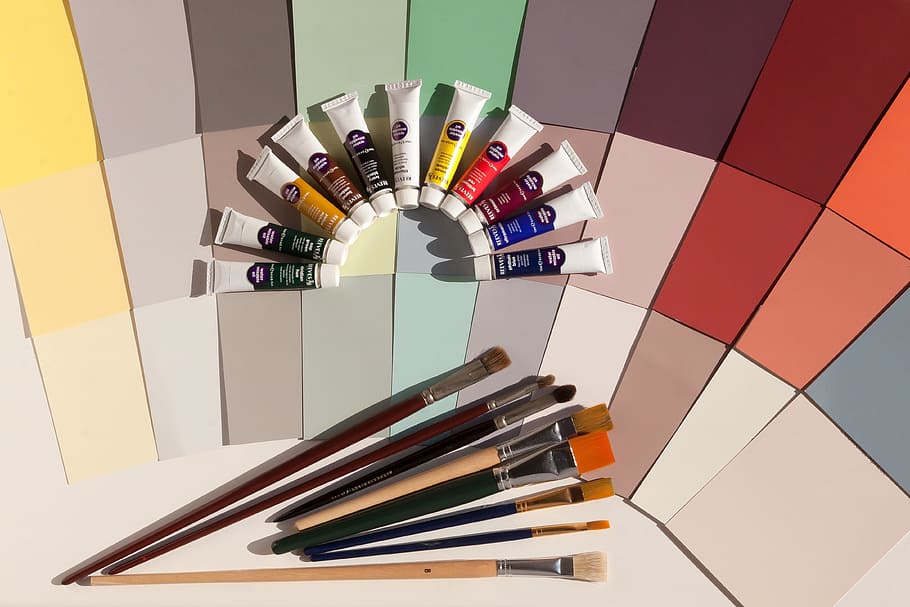 photo of assorted-color paint brushes and paint color soft tubes HD wallpaper