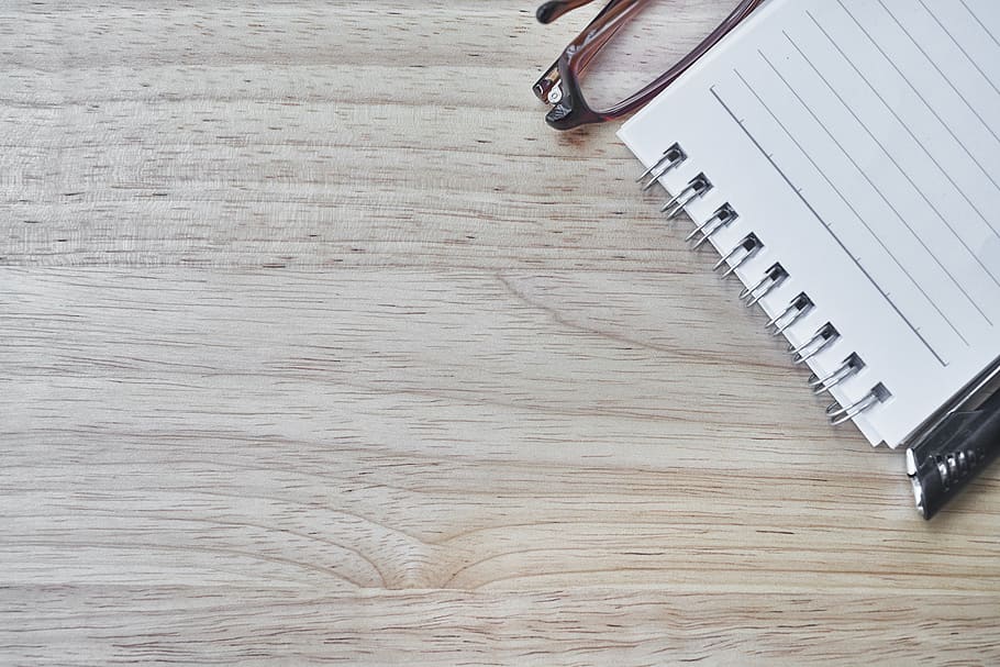 white spiral notes on brown slab, notebook, pen, eyewear, article HD wallpaper