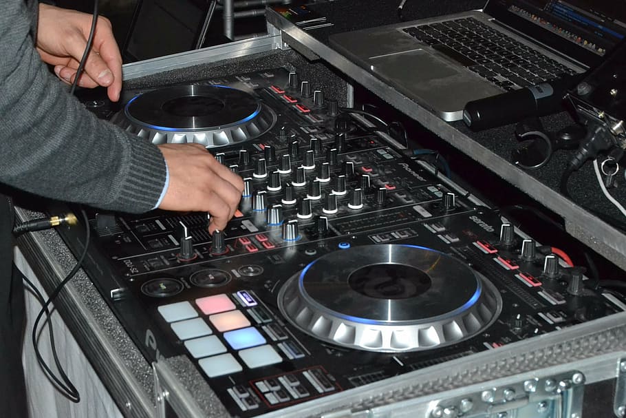 person using black DJ controller, deejay, party, turntable, music