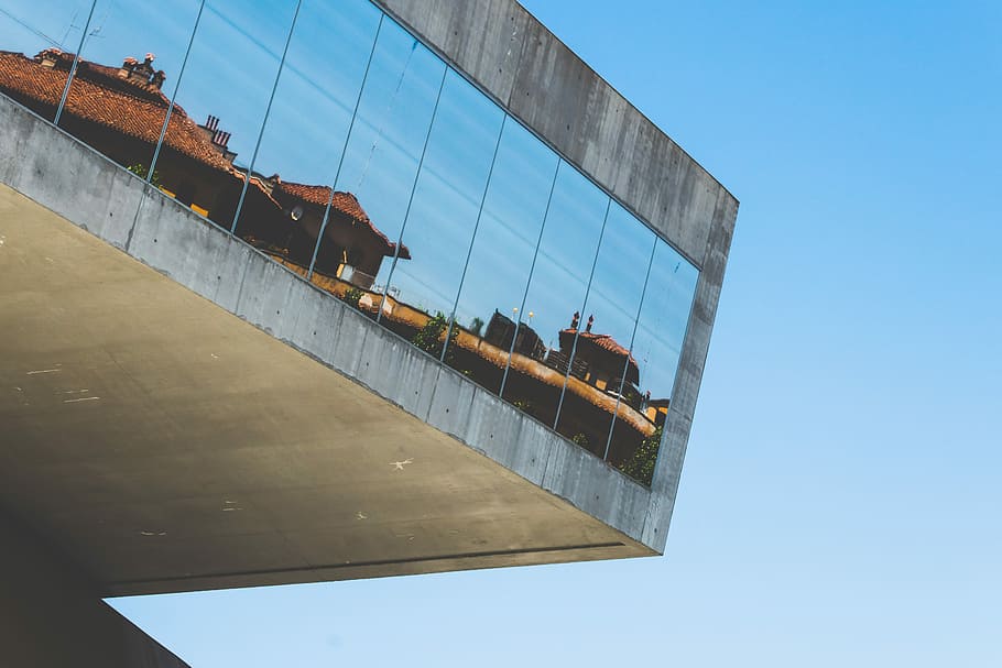 gray building with mirror glass windows at daytime, reflection of houses on building windows during daytime HD wallpaper