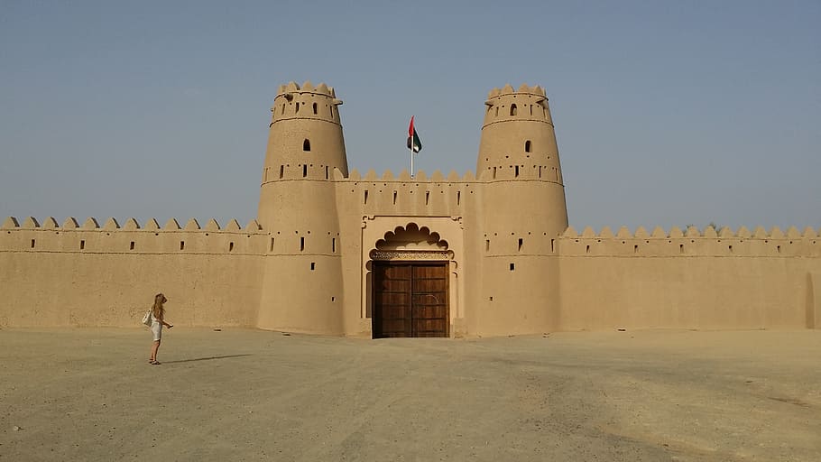woman walking towards building at daytime, al ain, uae, castle HD wallpaper