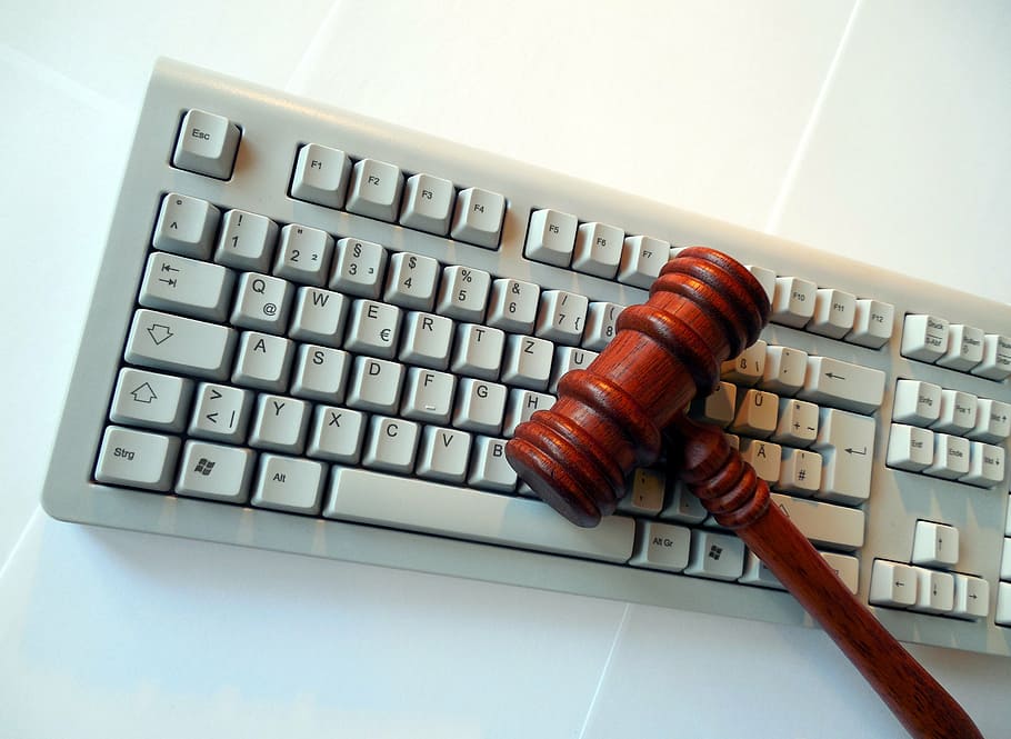gavel on top of white keyboard on white surface, privacy policy