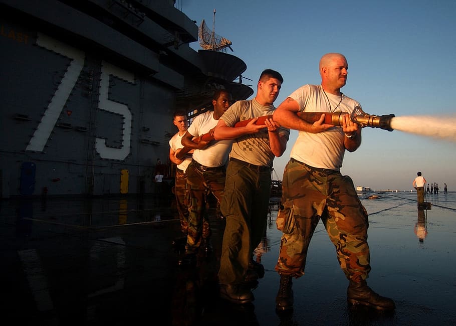 four man holding hose under blue sky, sailors, ship, navy, military