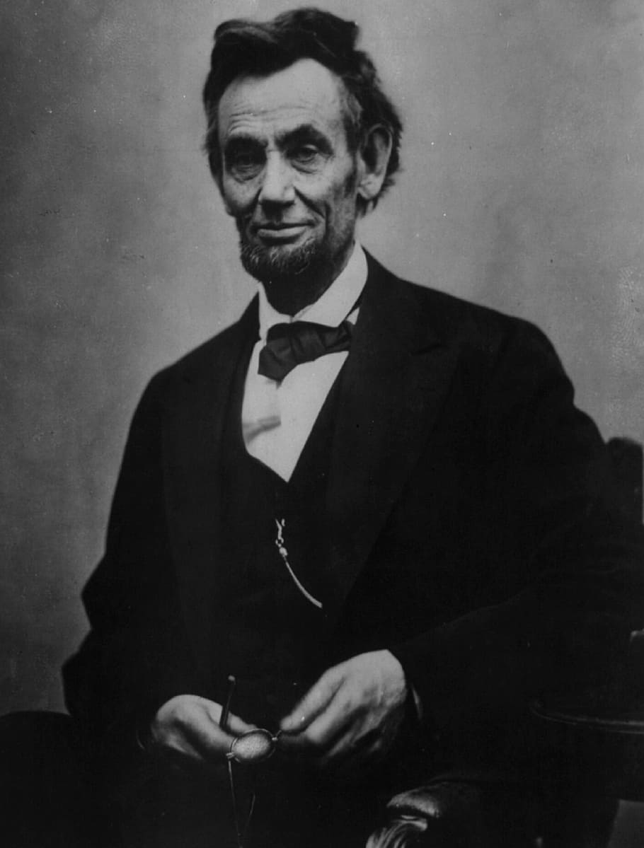 man wearing black top sitting on chair, president, abraham lincoln