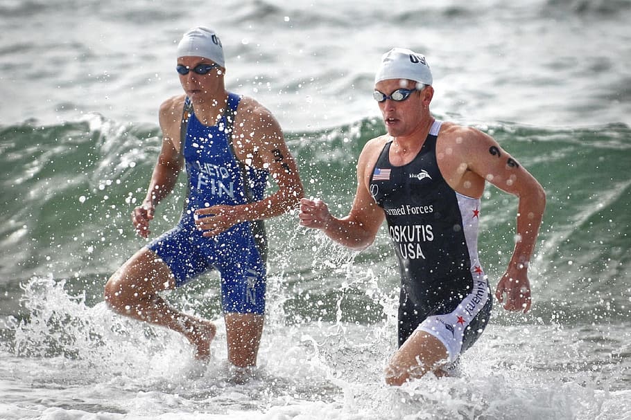 two men wading through water, swimming, competition, triathalon