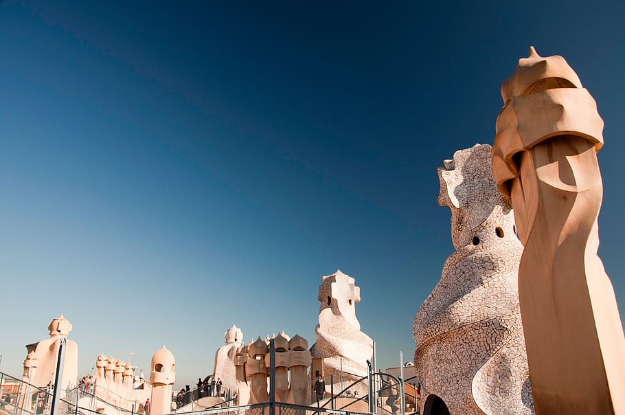 low angle photography of brown concrete statues and walls, casa mila