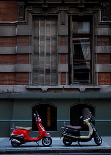 two motor scooters parked near building, red Vespa motor scooter HD wallpaper