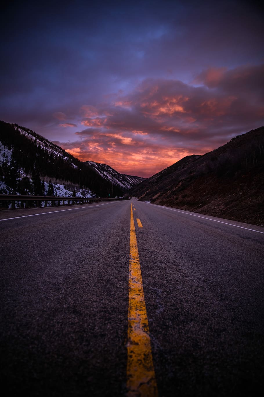 gray asphalt road between brown mountains under cloudy sky during daytime, concrete road towards mountain HD wallpaper