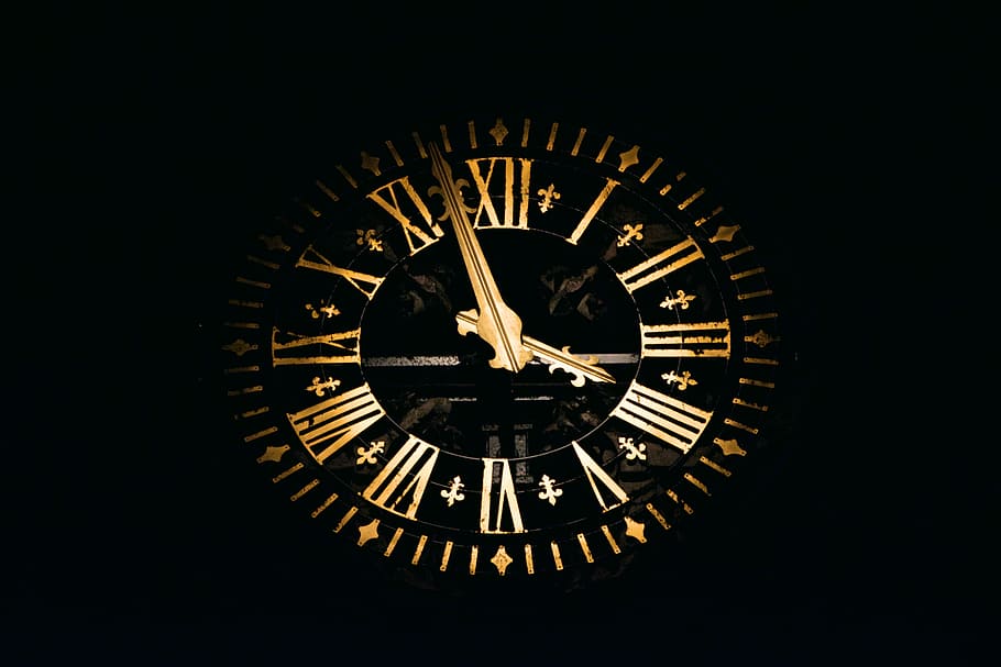 round black and brown analog clock, brown analog clock displaying 3:58
