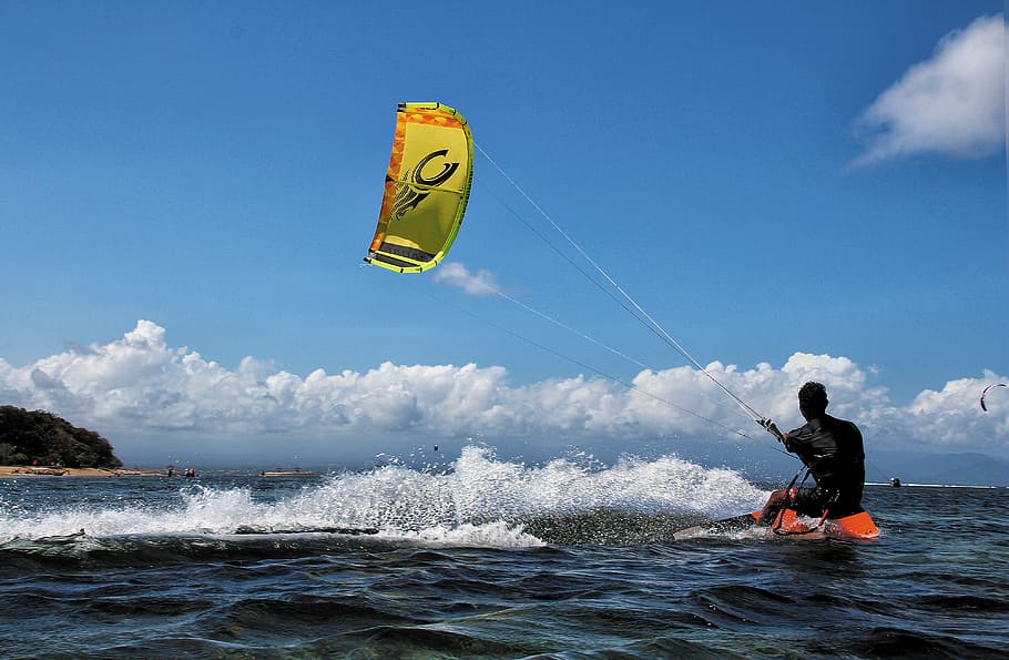 man on body of water while kite boarding, kite surfing, bali