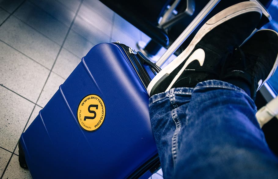 person wearing blue jeans resting foot on blue luggage, trolley, HD wallpaper