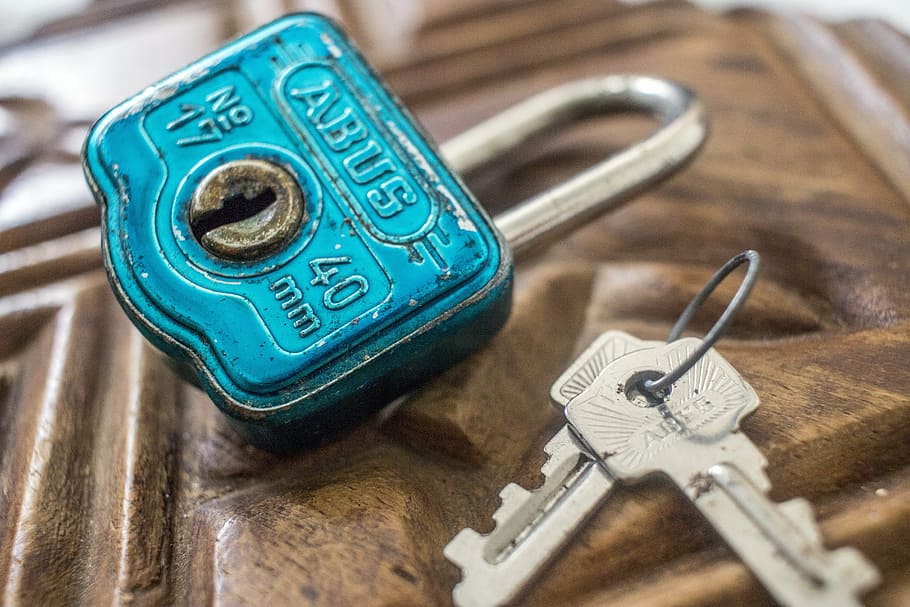 two gray keys beside teal padlock, vintage, creative, security
