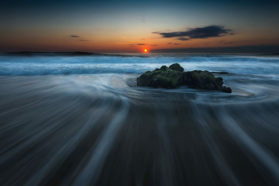 photo of islet, timelapse photography of rock at beach during sunset HD wallpaper