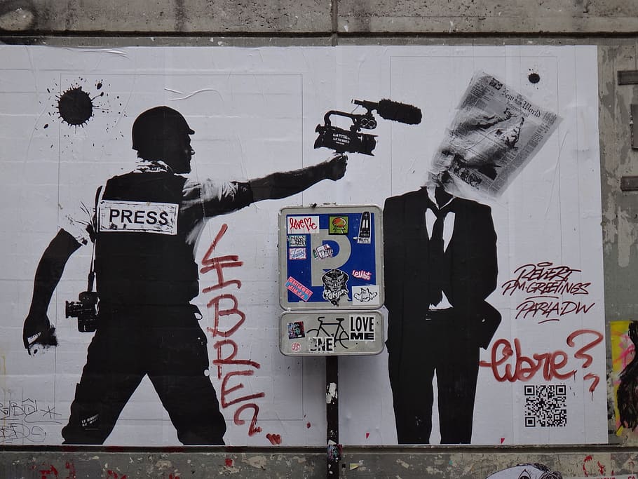graffiti of man holding camera pointing to man in black suit jacket HD wallpaper