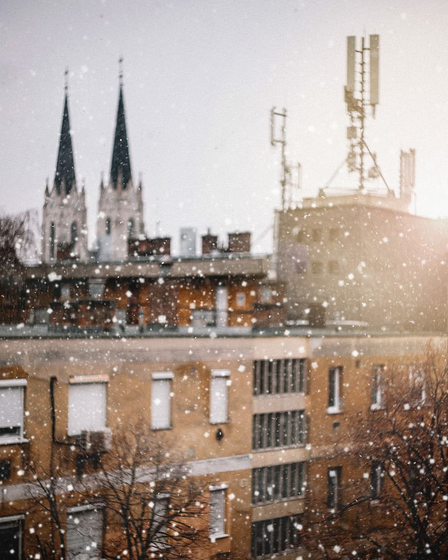 photo of a snow weather and brown concrete building, gray concrete building under cloudy sky HD wallpaper