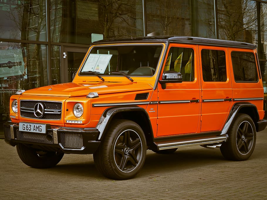 HD wallpaper: orange Mercedes-Benz G-class SUV parked on gray pavement ...