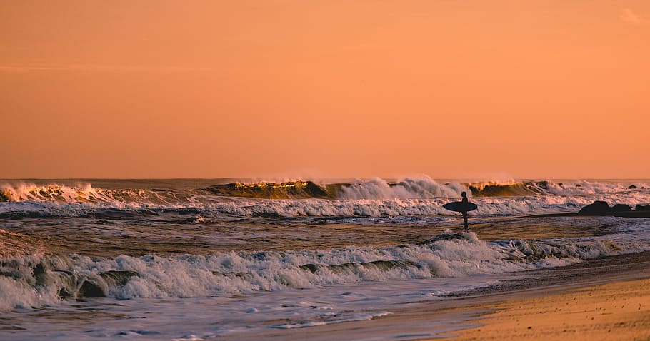 Surfer standing in shallow water, looking at waves at sunset in Bradley Beach, person standing on sea waves HD wallpaper