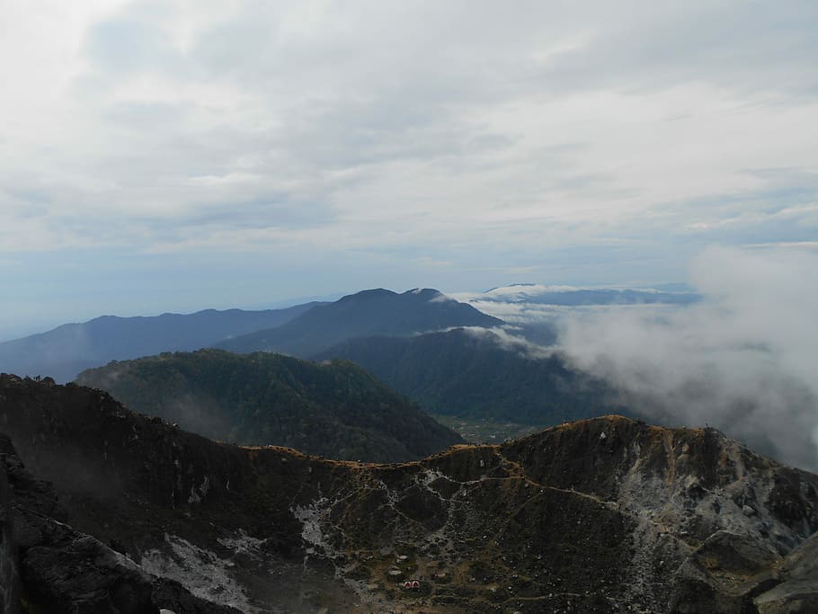 aerial photo of mountain covered by white smoke at daytime, foggy moutains under blue sky HD wallpaper
