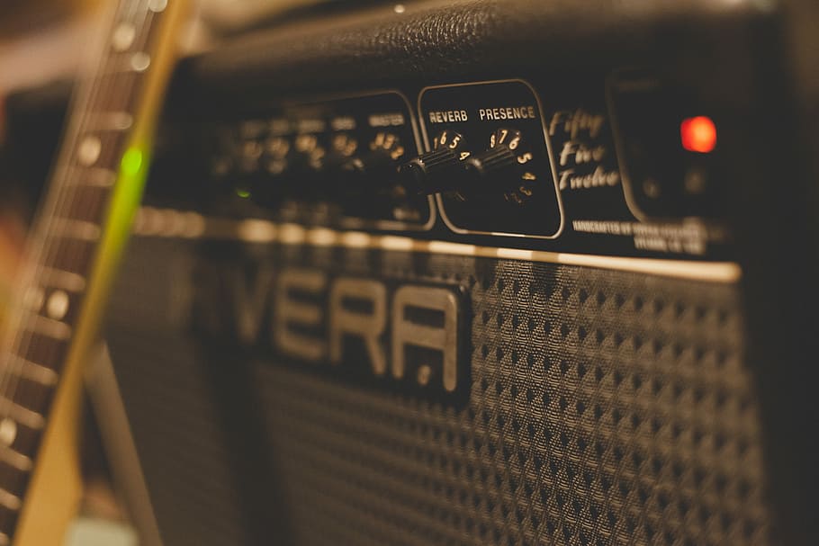 close up photography of guitar amplifier, selective focus photography of black Rivera guitar amplifier with leaning brown guitar HD wallpaper