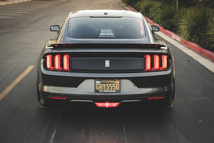 black and red car, turned on taillights, mustang, ford, driving